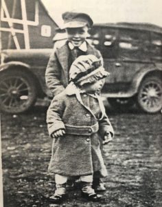 Daniel and Maynard as small children in front of the car and the barn