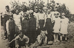 Ted in the back row wearing a cap (you can't see his face).  Marvin--first on the left front row. Daniel in the middle front row. 